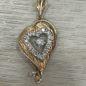 14 karat yellow gold necklace with diamond fancy open heart pendant